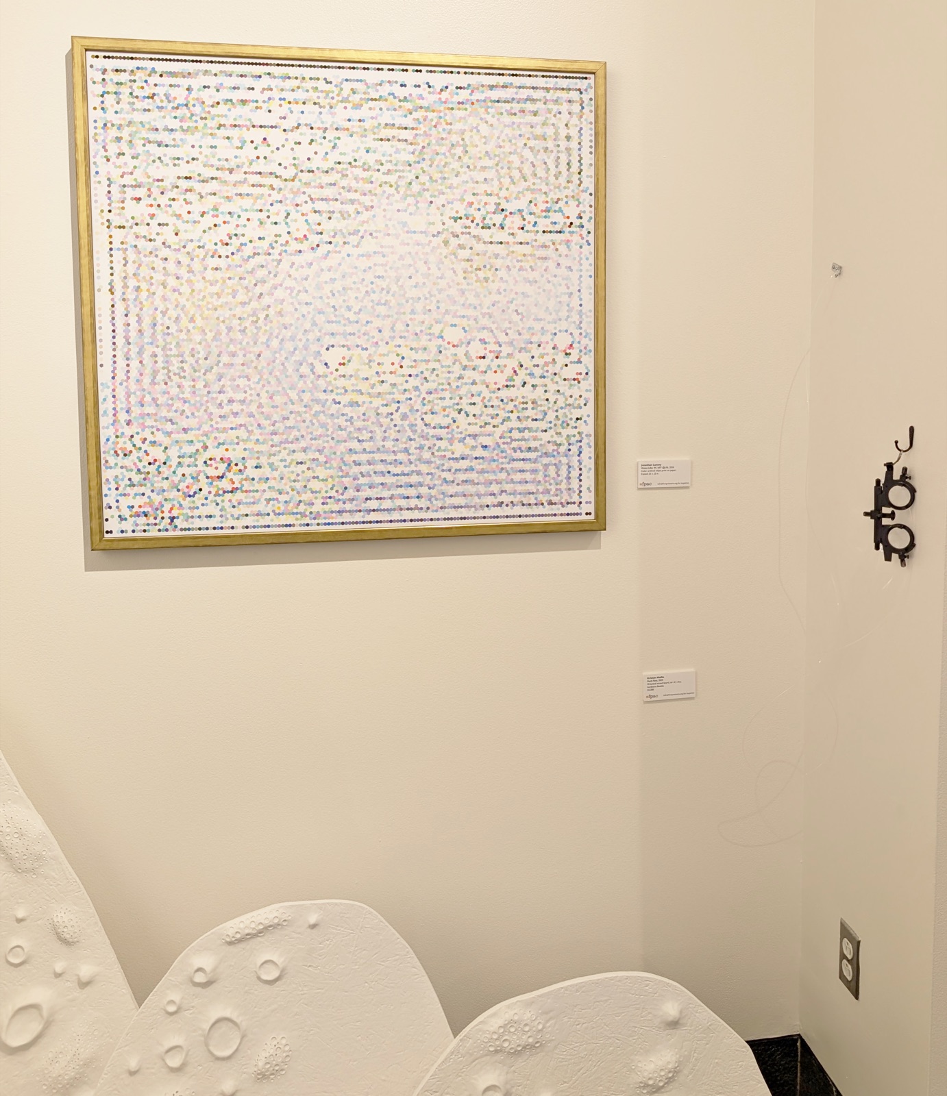 Water-Lilies W.1697 @r36 — a framed hex-mosaic print of Monet's water lilies on the gallery wall, beside a white sculptural form.